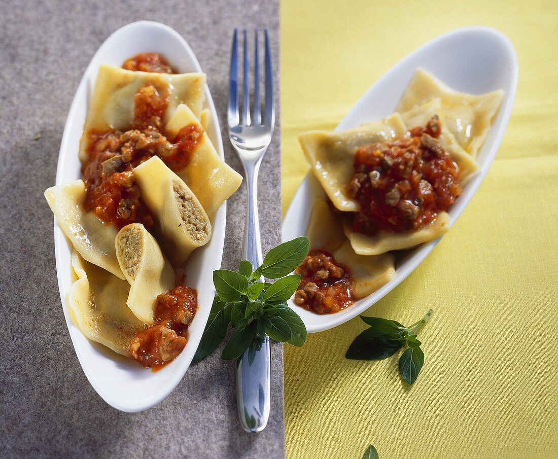 Pasta parcels with meat filling and mince and tomato sauce