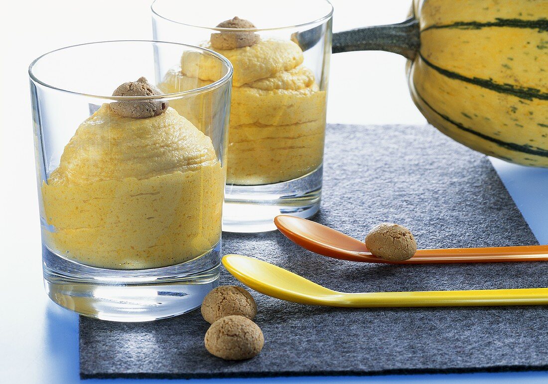 Pumpkin and apple cream with amaretti in glasses