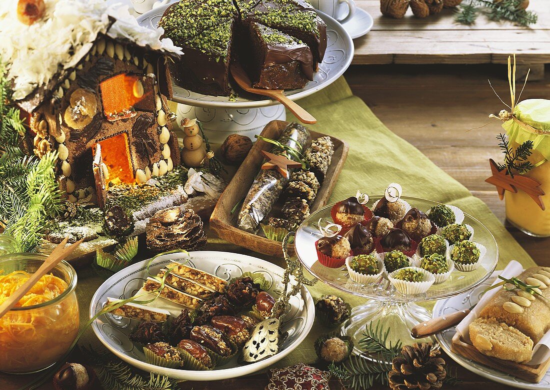 Christmassy cake buffet with sweets and gingerbread house