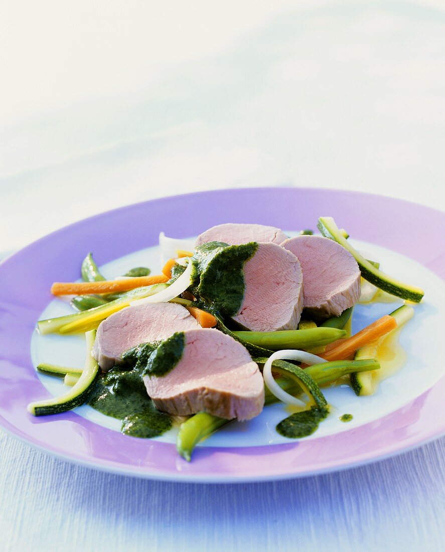 Poached veal fillet on julienne vegetables with salsa verde