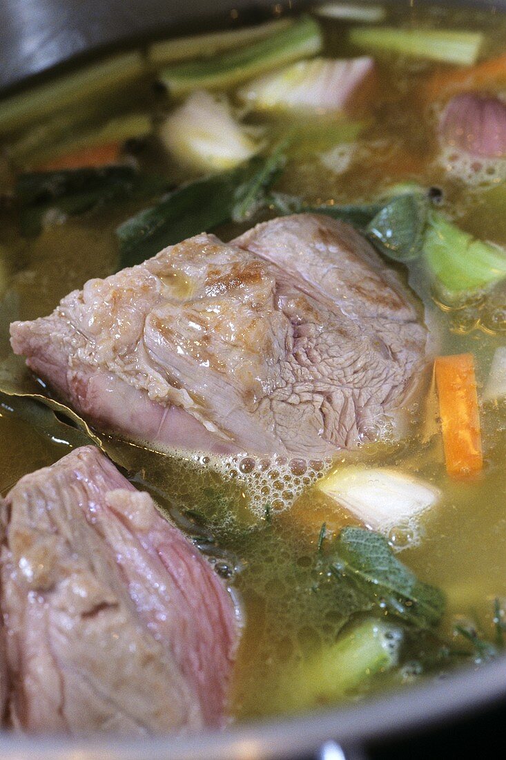 Stewing meat with vegetables cooking in pan