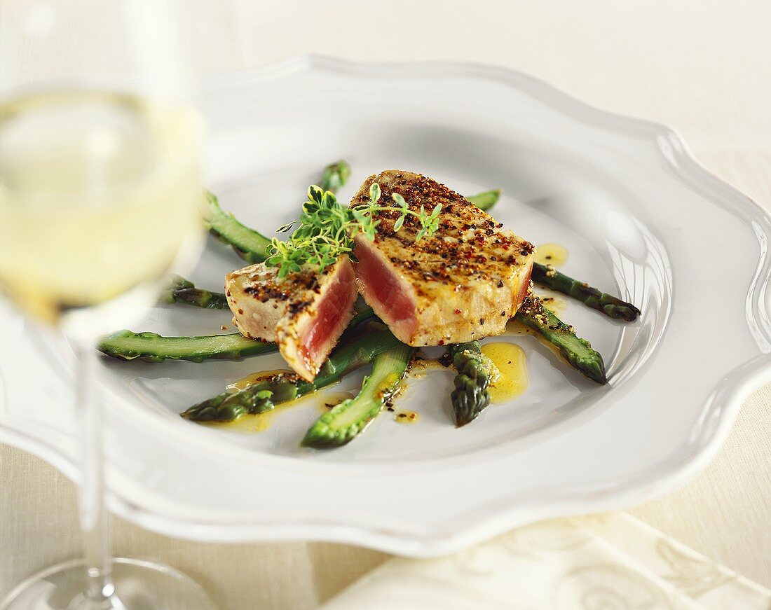 Tuna steak on green asparagus