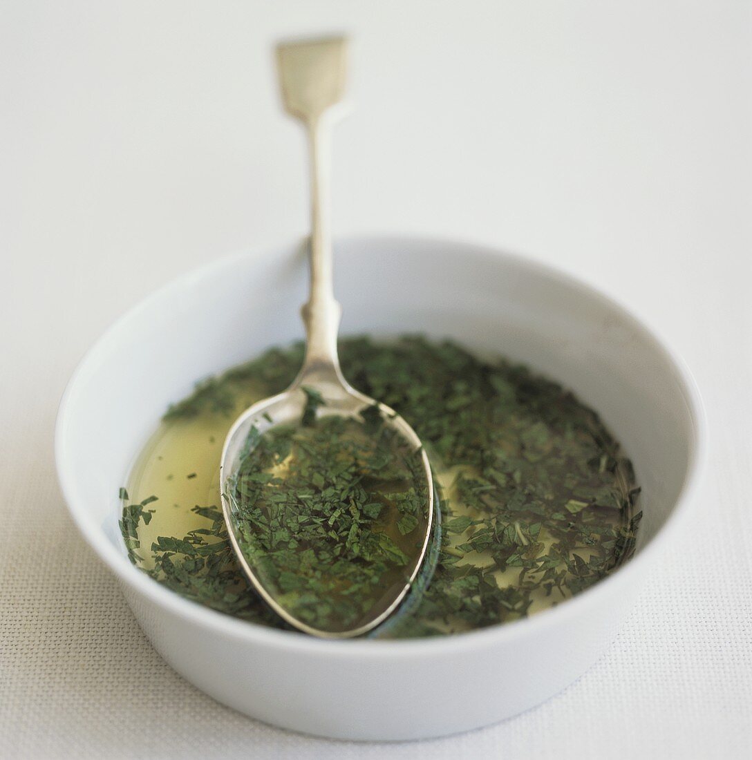 Mint sauce in small white bowl