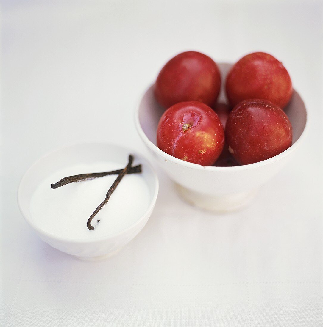 Red plums, sugar and vanilla pods
