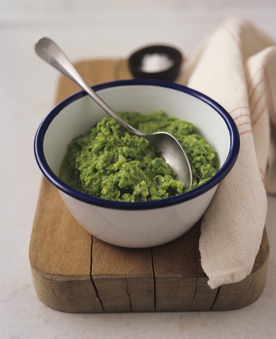 Pea puree in dish with spoon