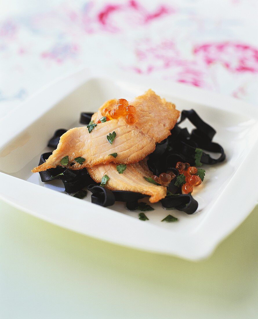 Black ribbon pasta with salmon fillet and caviare