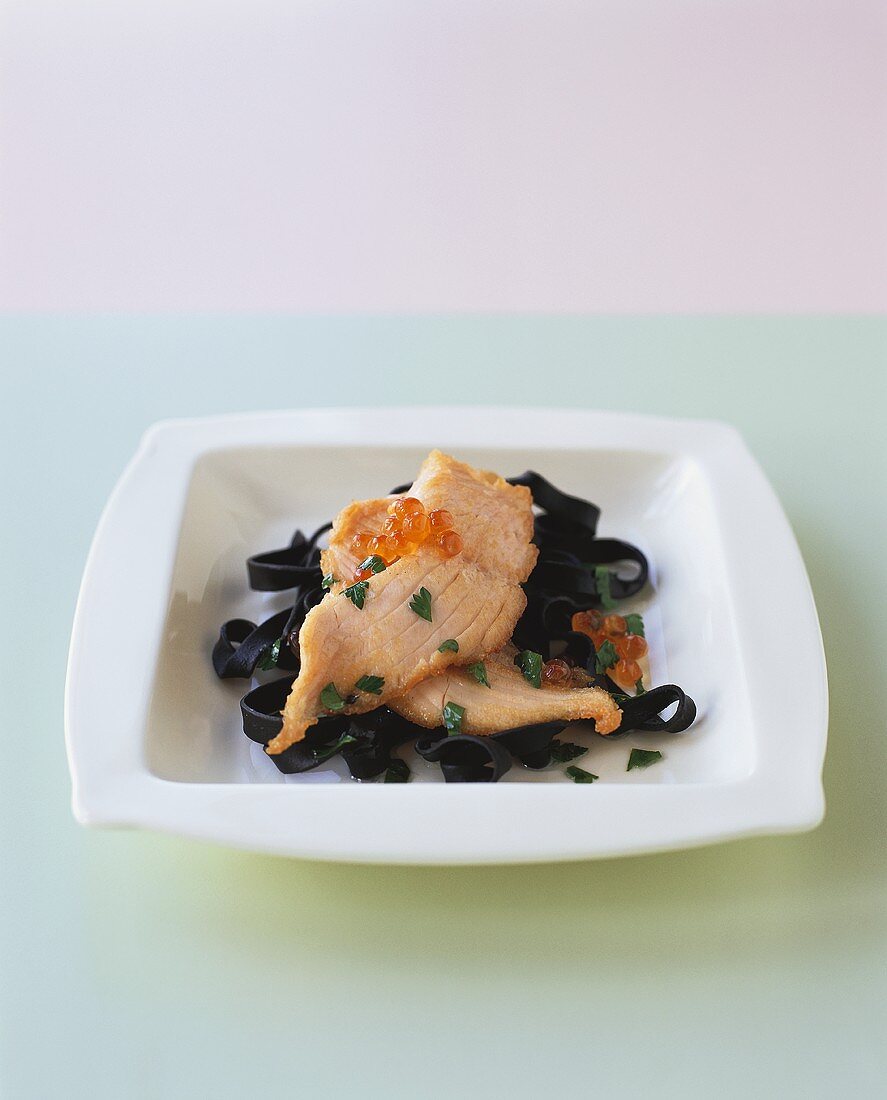 Black ribbon pasta with salmon fillet and caviare
