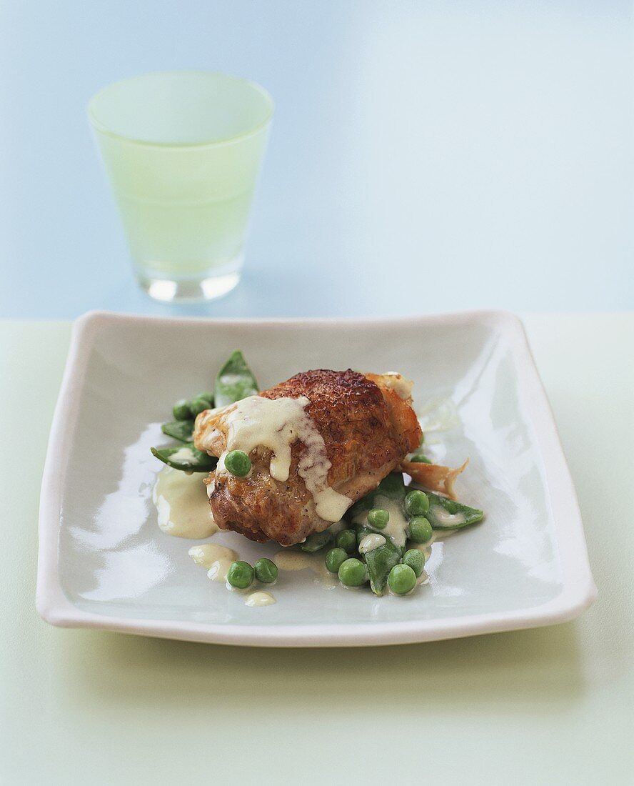 Chicken with peas, beans and white sauce