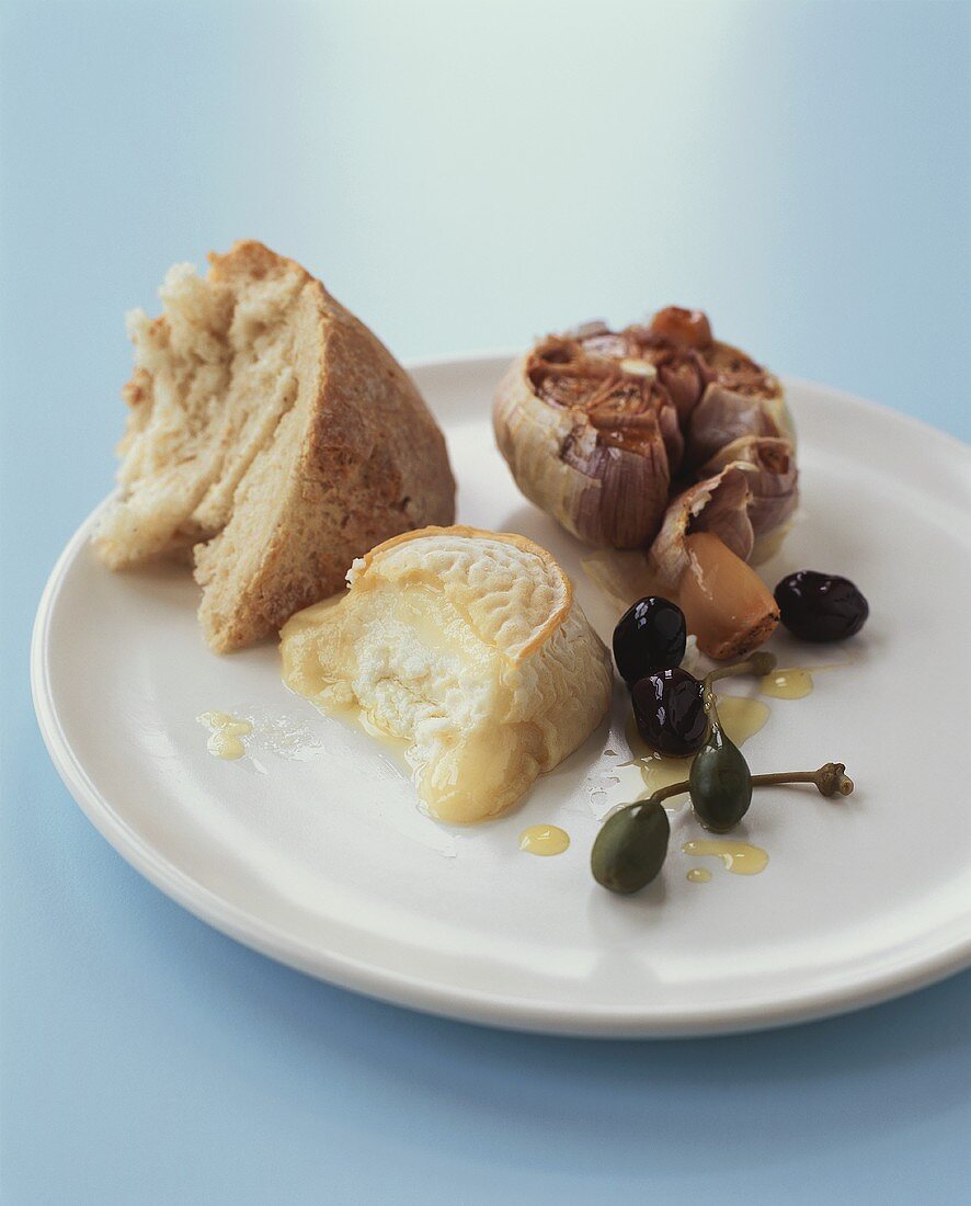 Warm Brie, roasted garlic, olives and white bread