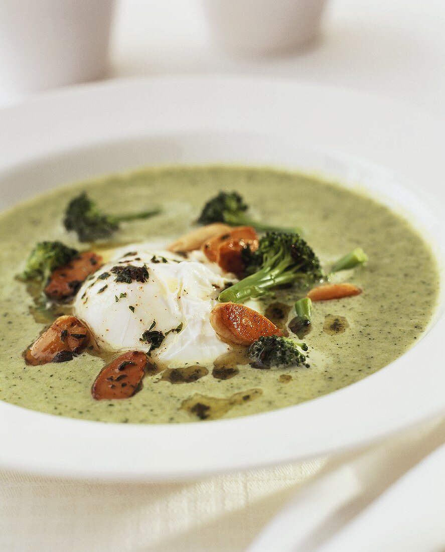 Broccoli soup with poached egg and toasted almonds