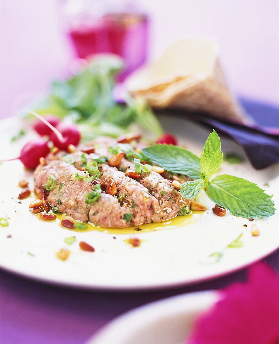 Mince with pine nuts, radishes and mint