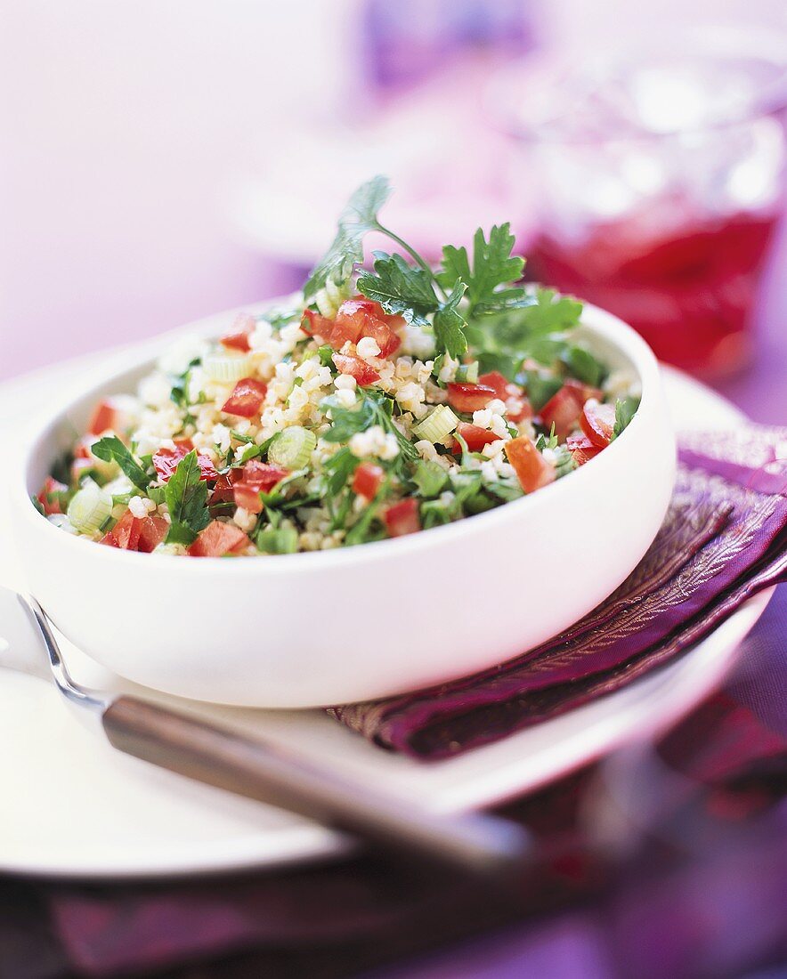 Couscous salad with peppers, spring onions and herbs