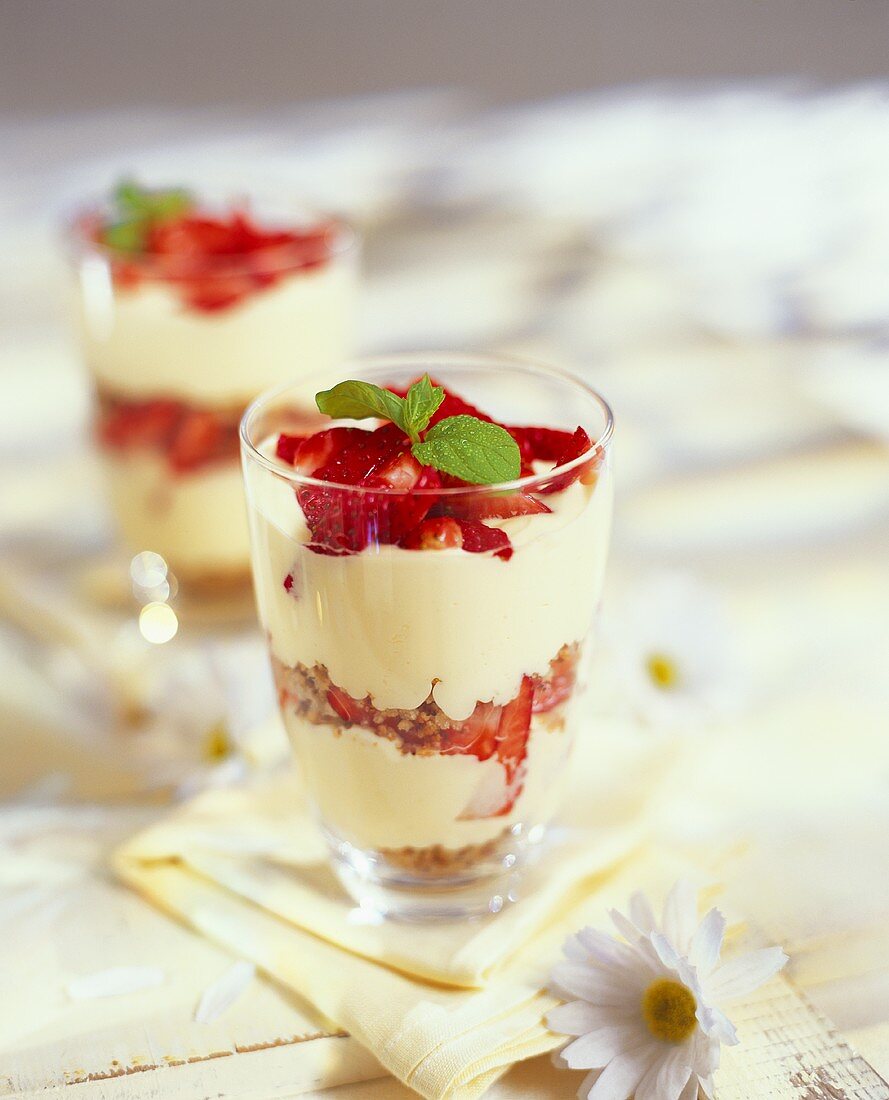 Layered dessert with vanilla cream and fresh strawberries