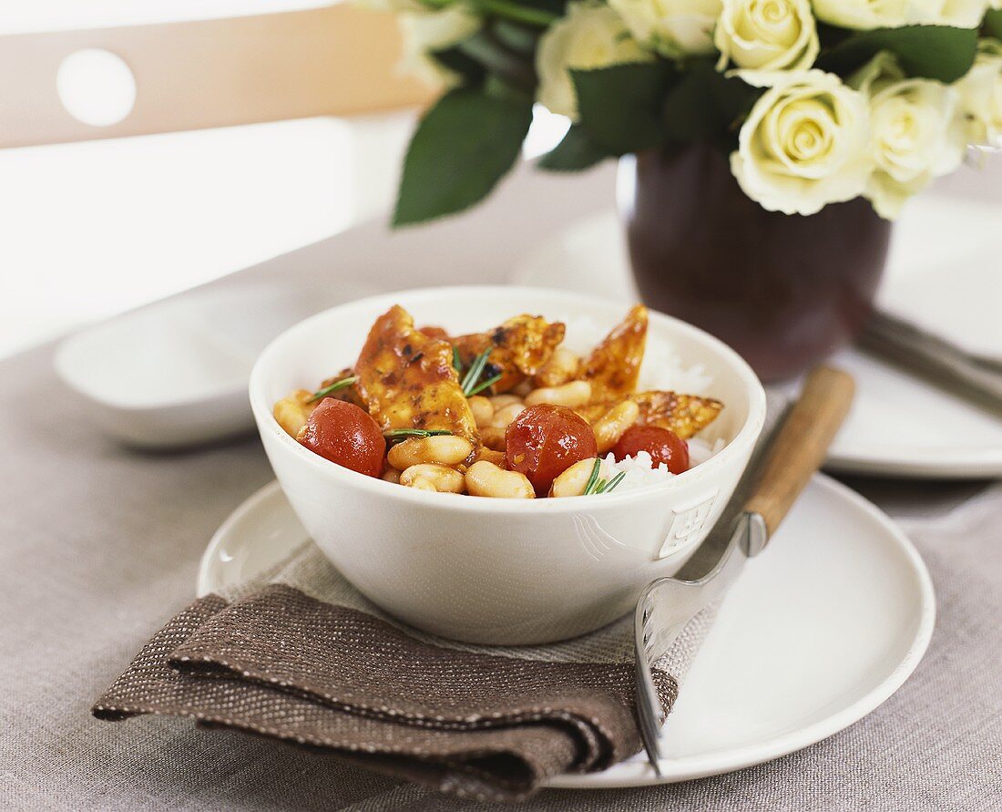 Chicken, white beans and cherry tomatoes on rice