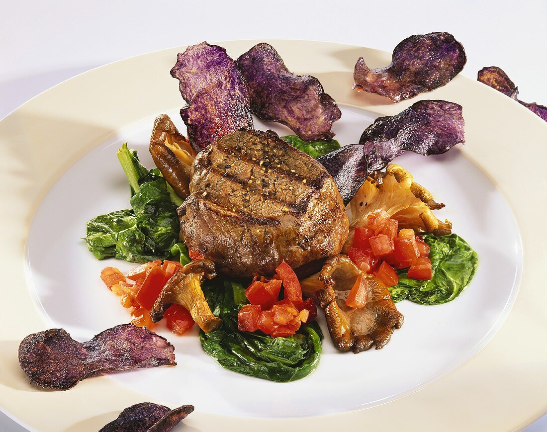 Beef fillet with blue potato crisps, mushrooms and spinach