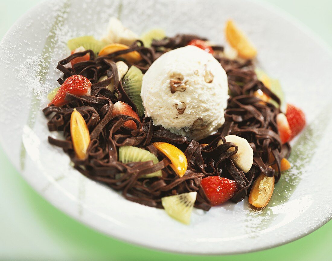 Walnut ice cream on chocolate noodles with fruit