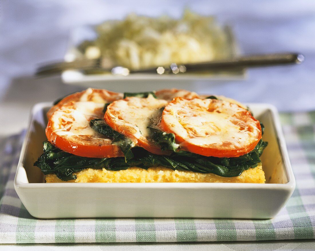 Polenta bake with spinach and tomatoes