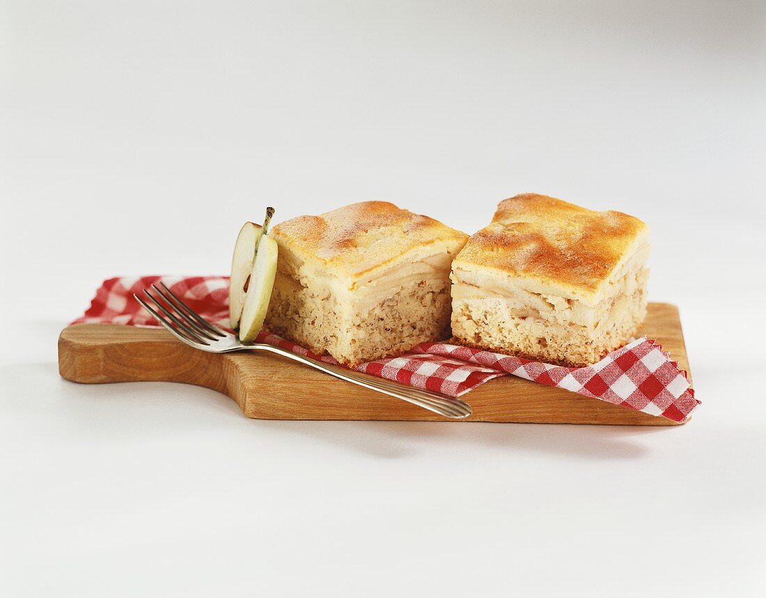 Two pieces of honey apple cake on chopping board