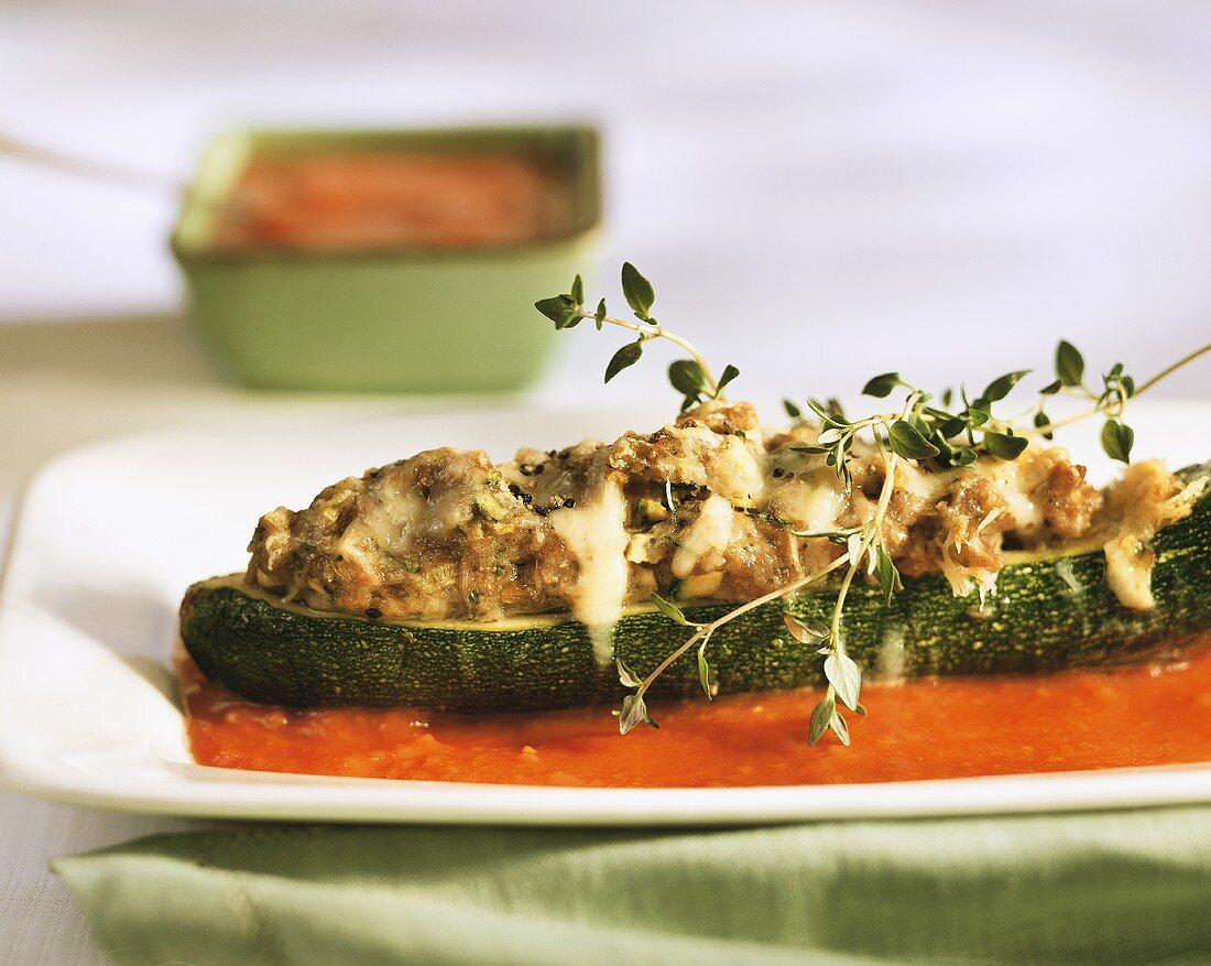 Stuffed courgettes with cheese topping in tomato sauce