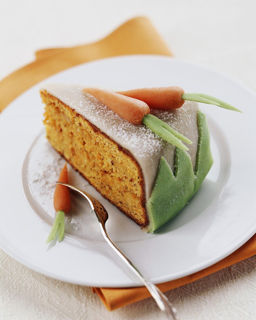 Piece of carrot cake with marzipan carrots