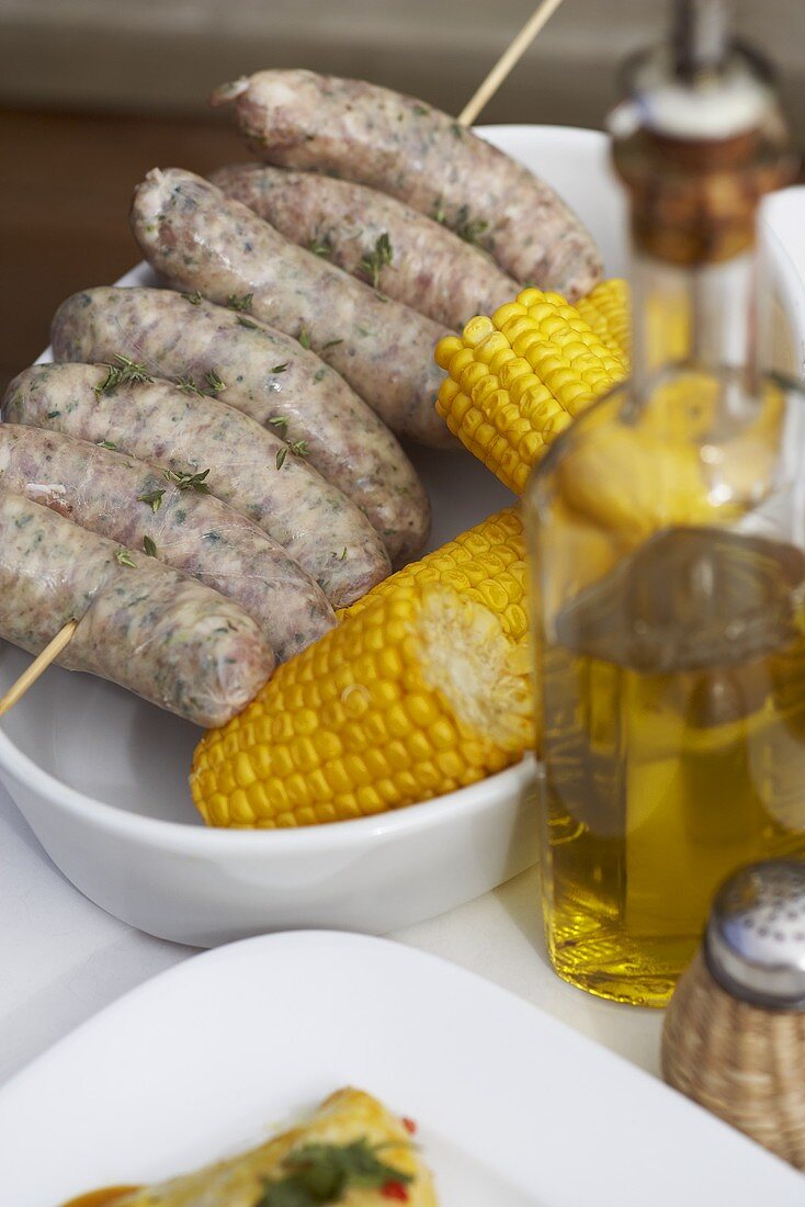 Sausages, corncobs and olive oil