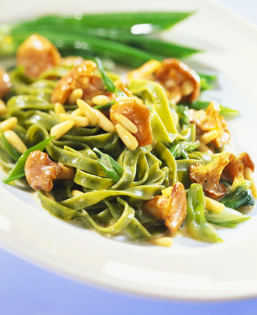 Green tagliatelle with chanterelles and pine nuts