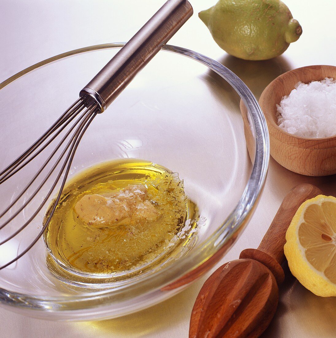 Vinaigrette in glass bowl with mustard, lemon and salt