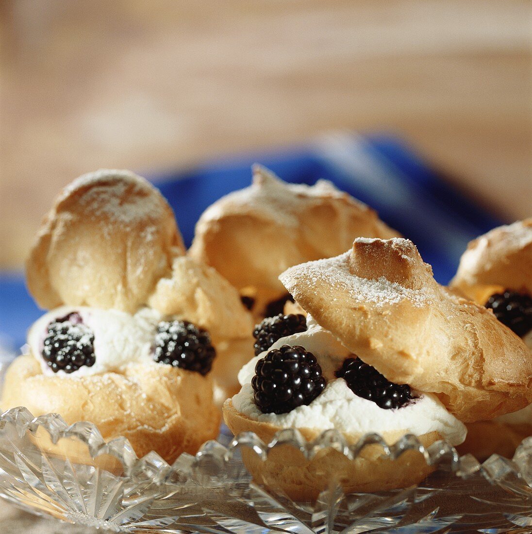 Cream puffs with cream and blackberries