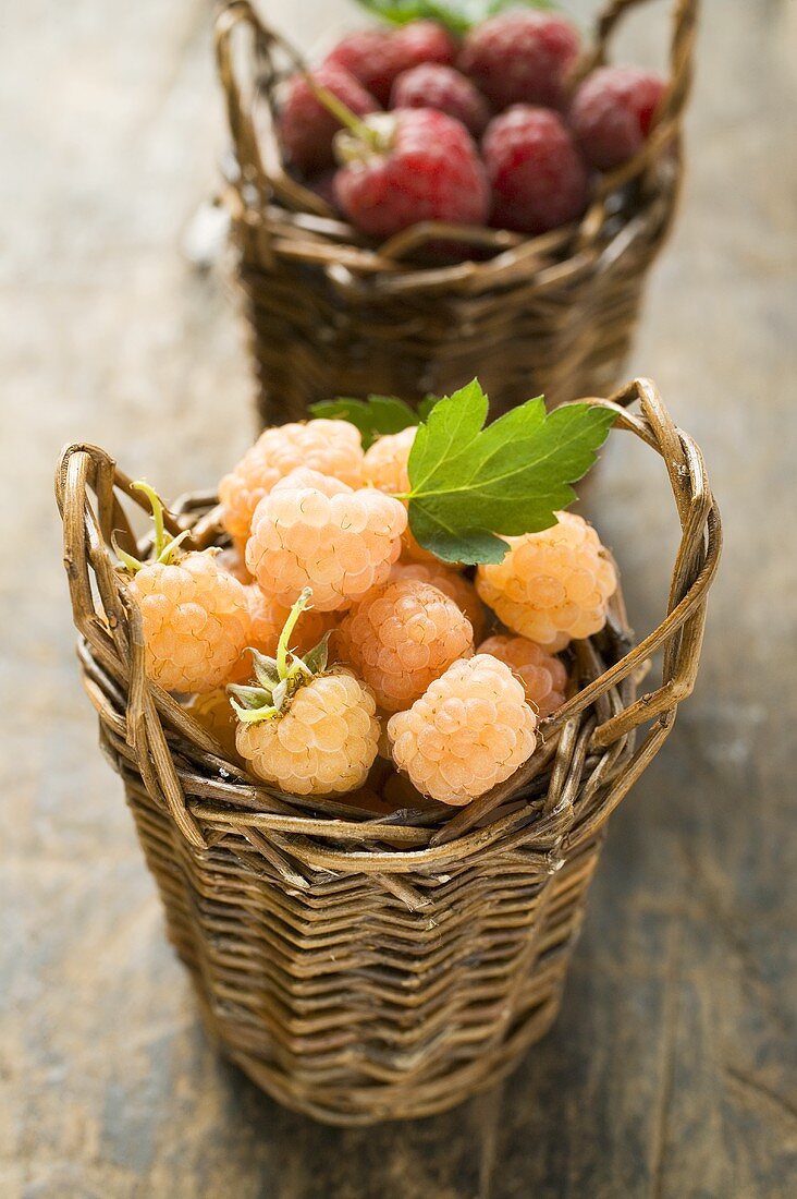 Yellow and red raspberries in two small baskets