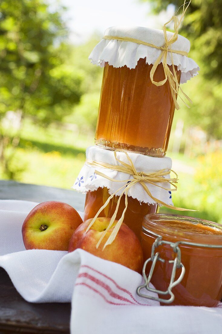 Nectarine jam in jars on table in the open air