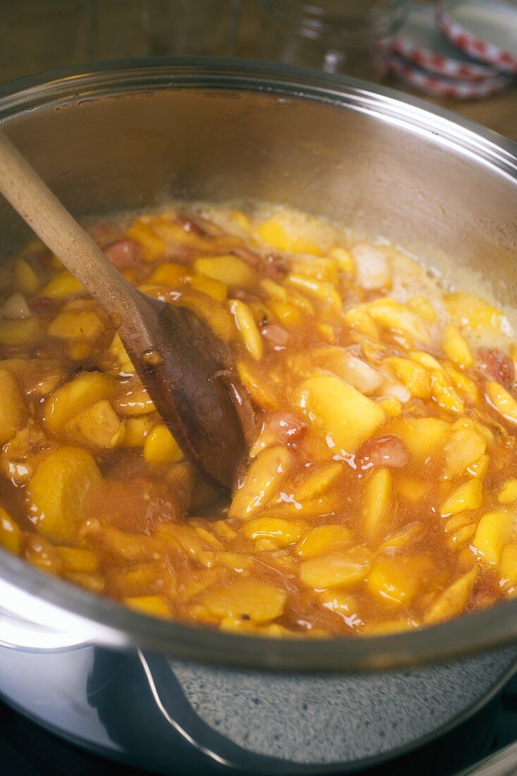 Making nectarine jam (stirring the fruit & sugar in the pan)