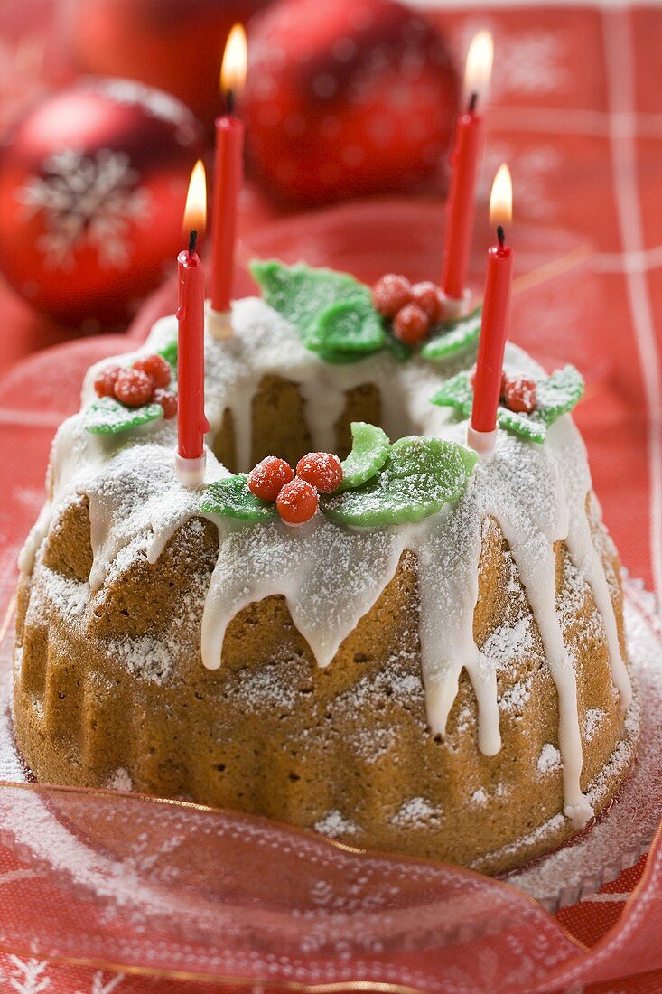 Iced walnut gugelhupf with candles for Christmas