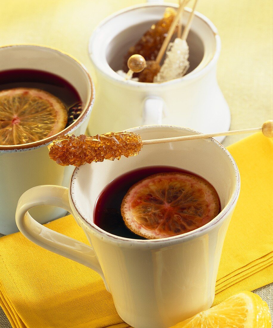 Elderberry punch with slices of lemon & sugar swizzle sticks