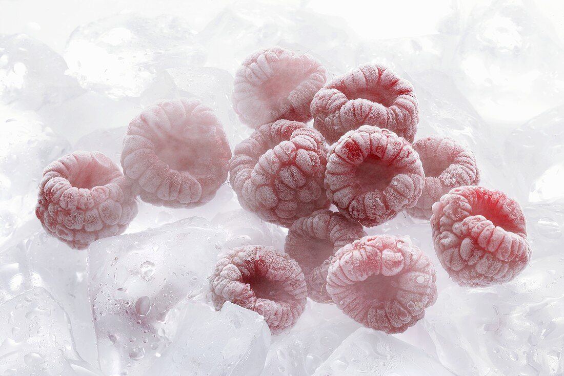 Frozen raspberries on ice cubes