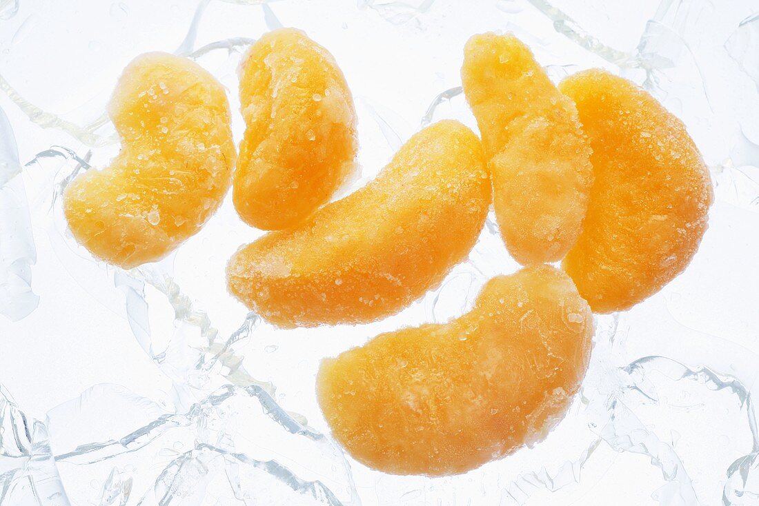Frozen mandarin orange segments on ice cubes