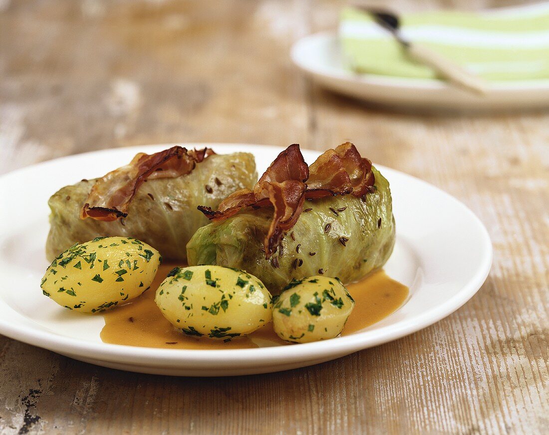 Stuffed cabbage leaves with bacon and parsley potatoes