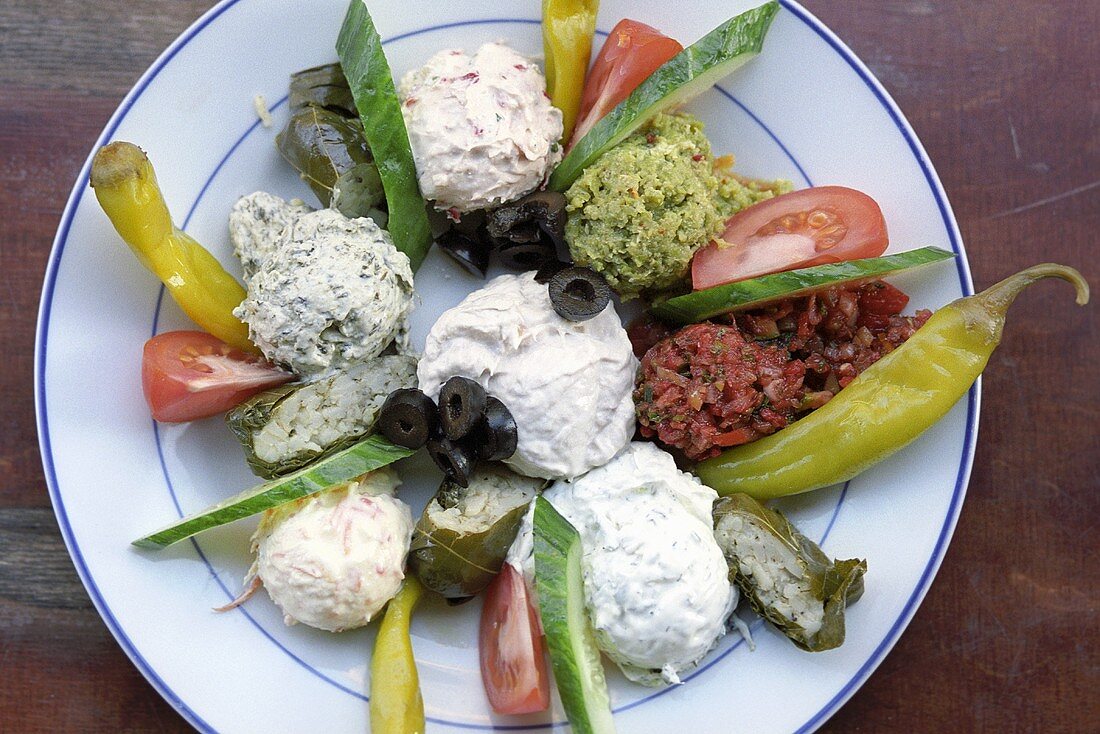 Plate of Mediterranean appetisers: dips and vegetables