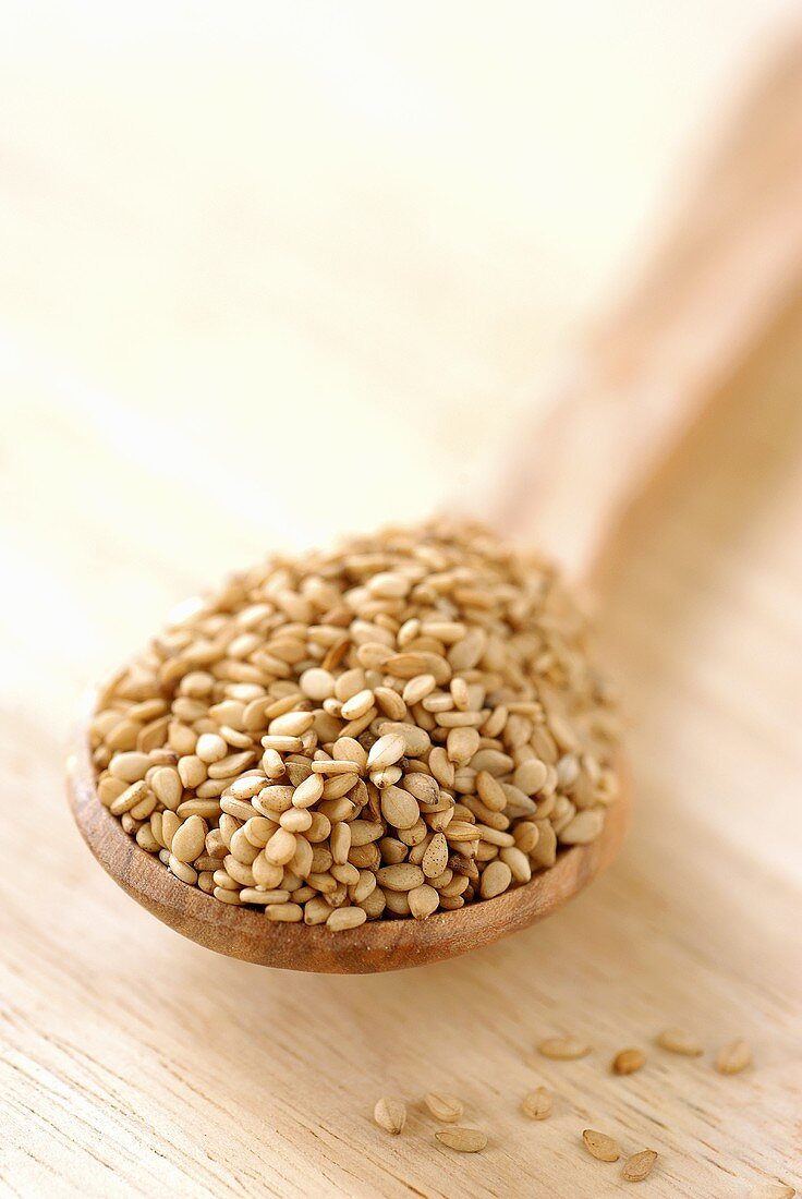 Sesame seeds on wooden spoon