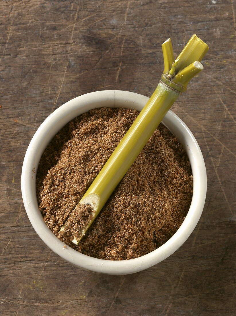 Five spice powder in bowl with bamboo cane