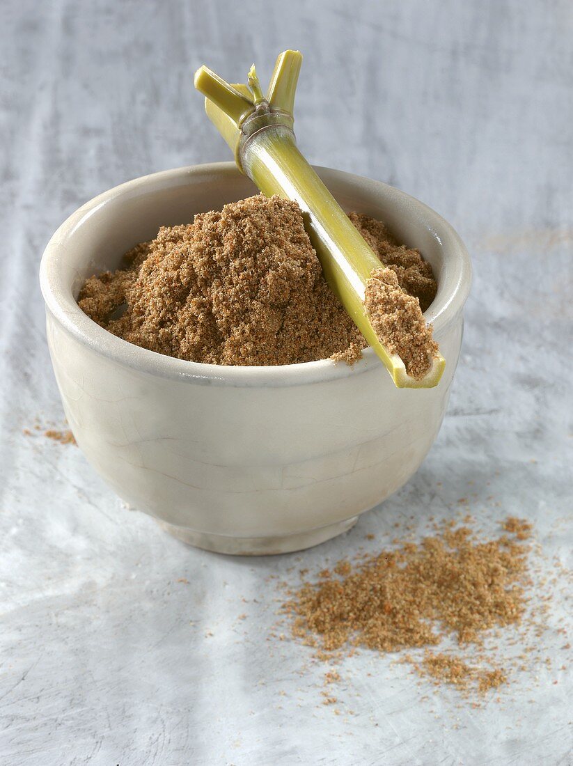 Five spice powder in bowl with bamboo cane