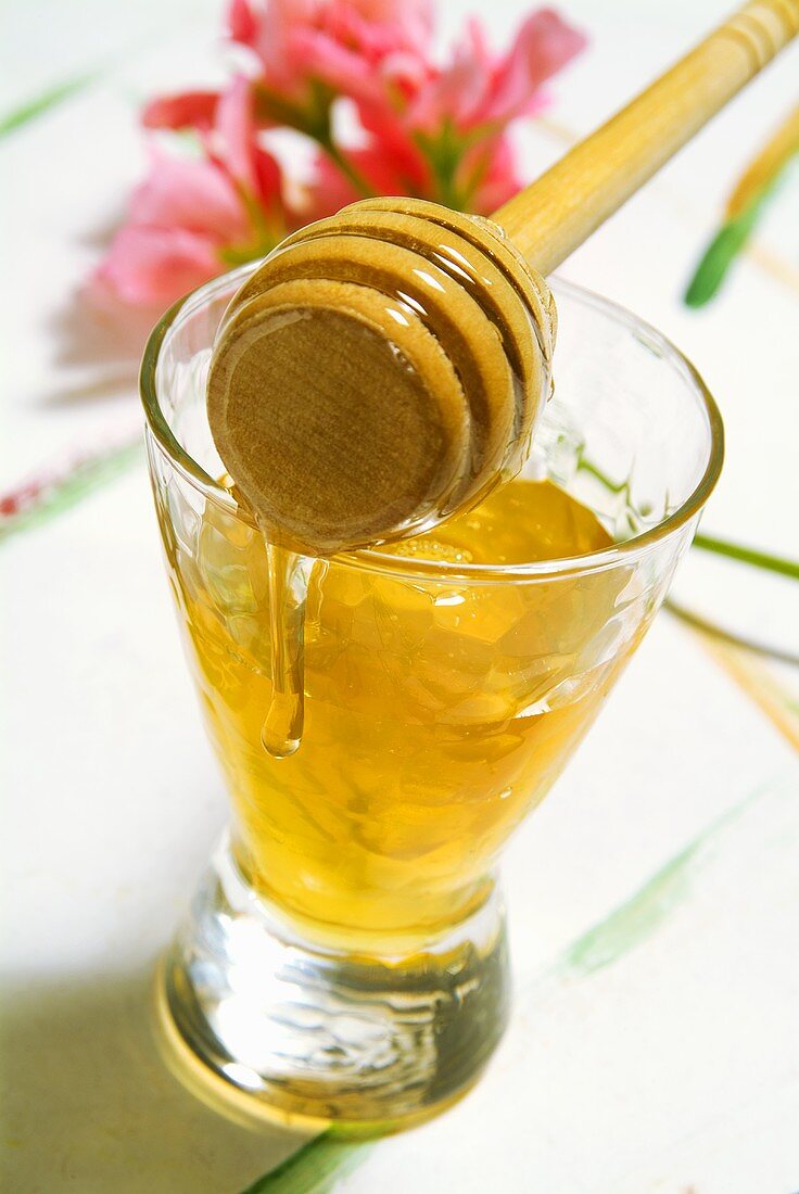 Honey in glass with honey dipper