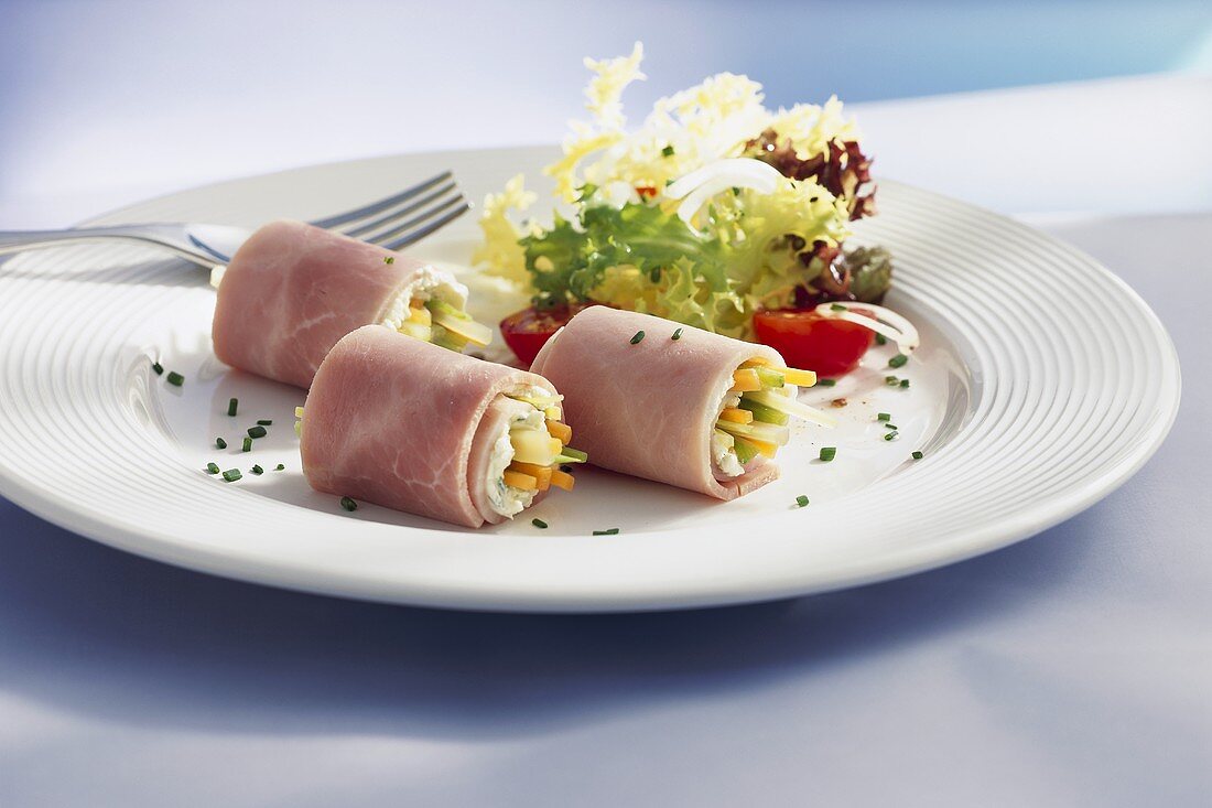 Ham rolls filled with vegetables and soft cheese