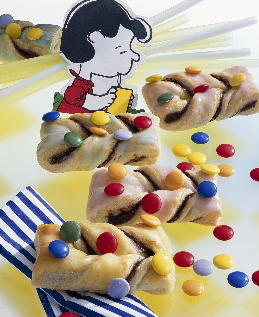 Puff pastry twists with coloured chocolate beans for children