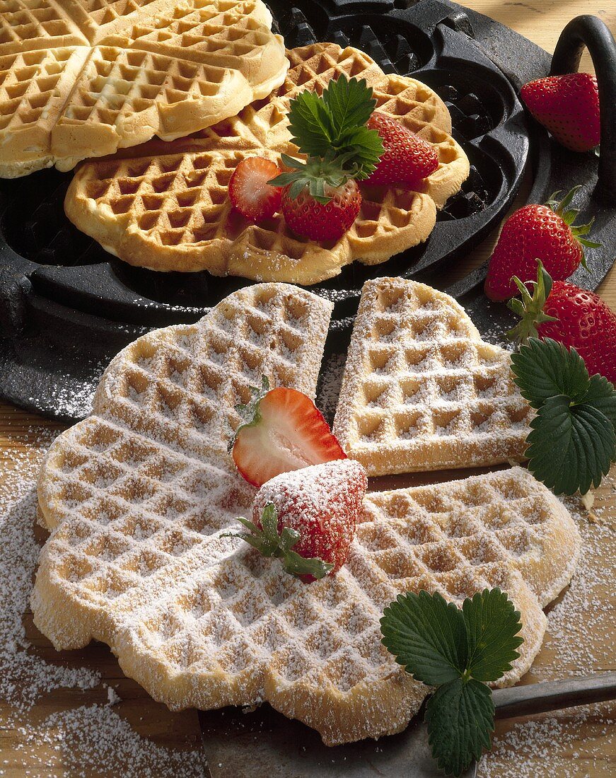 Waffles with strawberries and icing sugar