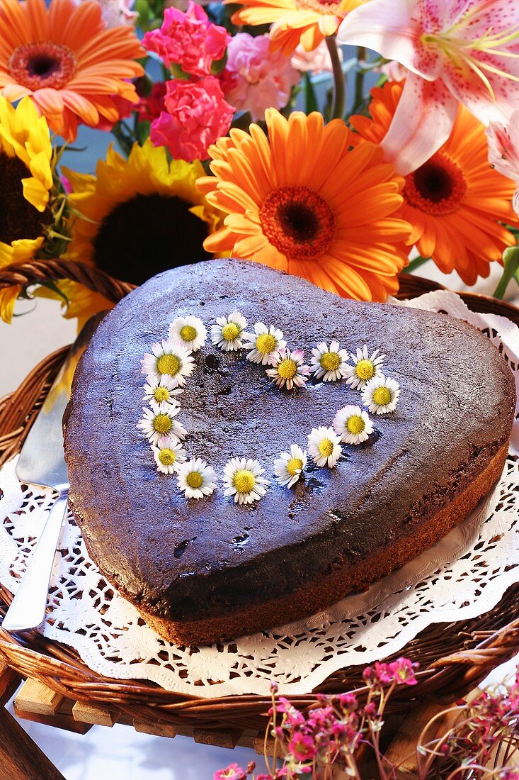 Heart-shaped chocolate cake with daisies