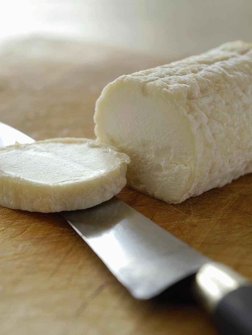 Goat’s cheese roll, a piece cut off