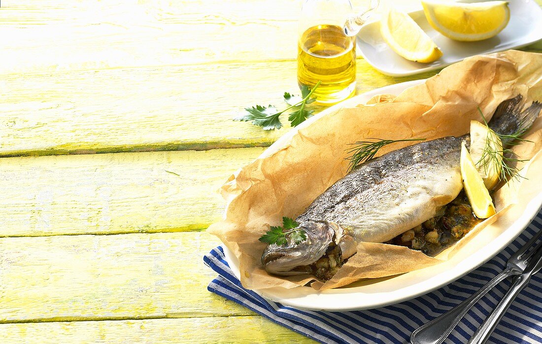 Stuffed trout with lemon in baking parchment