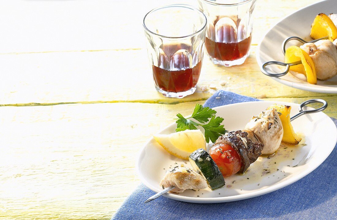 Chicken and vegetable kebabs and red wine (Greece)