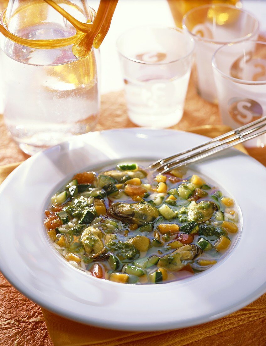 Mussel soup with vegetables and pesto