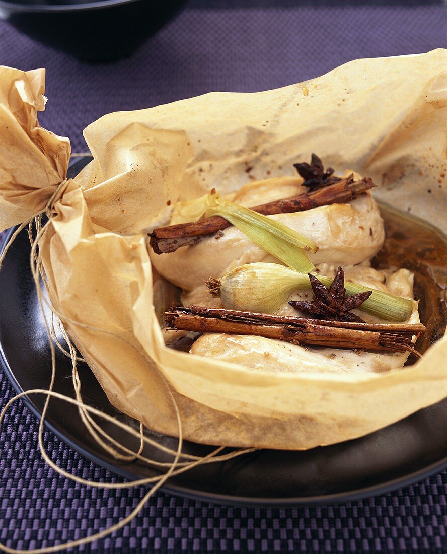 Chicken breast with cinnamon sticks & star anise in baking paper